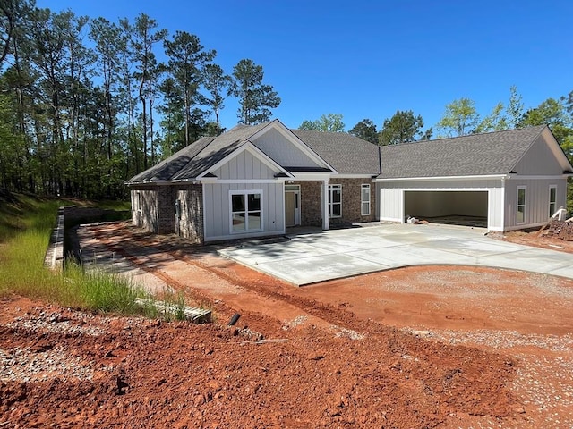 8033 Splendor Way, Columbus, GA 31904 - view of front of home with a shingled roof, concrete driveway, a garage, and board and batten siding