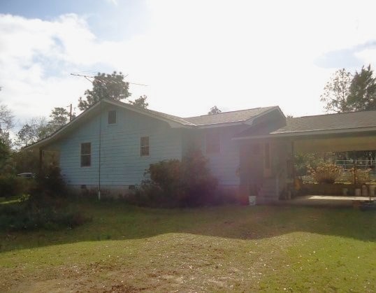 view of property exterior featuring a lawn