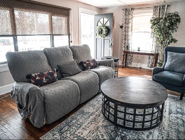 living area featuring baseboards and hardwood / wood-style flooring