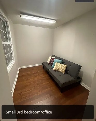 unfurnished room featuring baseboards and wood finished floors