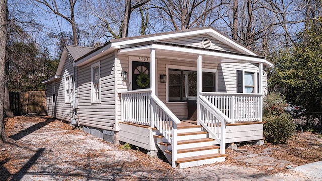 view of front of house with metal roof and a porch