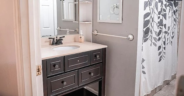 bathroom with curtained shower and vanity