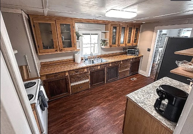 kitchen featuring white electric range oven, a sink, visible vents, dark wood-style floors, and glass insert cabinets