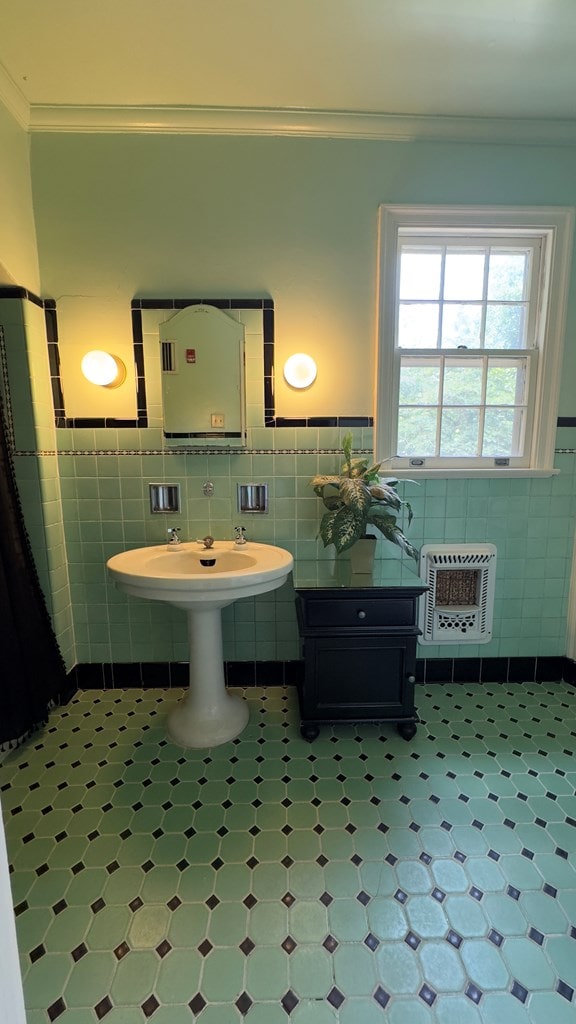 201 7th St, Columbus, GA 31901 - bathroom featuring tile walls, heating unit, tile patterned floors, ornamental molding, and a wainscoted wall