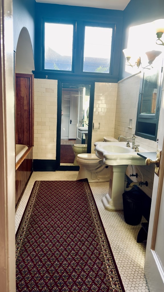 201 7th St, Columbus, GA 31901 - bathroom with a tub to relax in and a wainscoted wall
