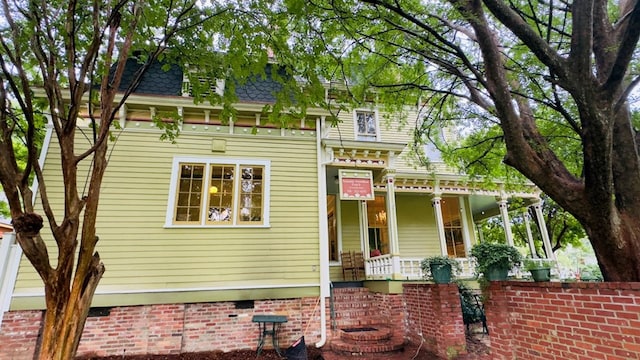 201 7th St, Columbus, GA 31901 - view of front of property with a porch, mansard roof, and roof with shingles