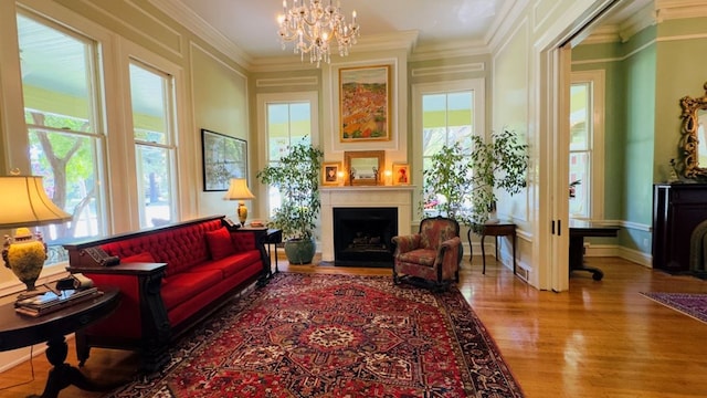 201 7th St, Columbus, GA 31901 - living area with wood finished floors, a fireplace, a chandelier, and ornamental molding