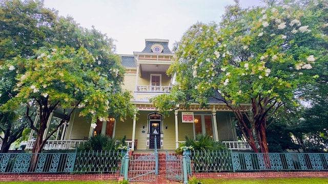201 7th St, Columbus, GA 31901 - view of front of house with covered porch, a gate, and a fenced front yard