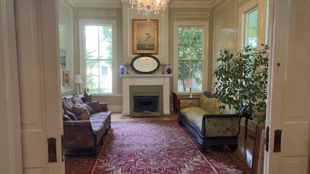 201 7th St, Columbus, GA 31901 - sitting room with a chandelier, a fireplace, wood finished floors, and crown molding