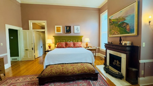 201 7th St, Columbus, GA 31901 - bedroom featuring wood finished floors, a fireplace, and ornamental molding