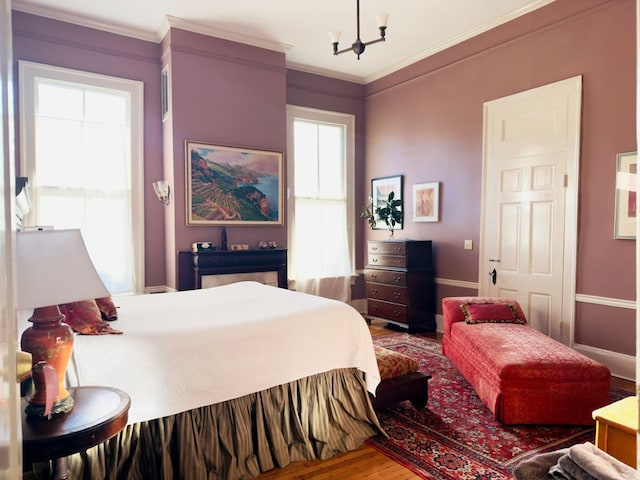201 7th St, Columbus, GA 31901 - bedroom with wood finished floors, a chandelier, and crown molding