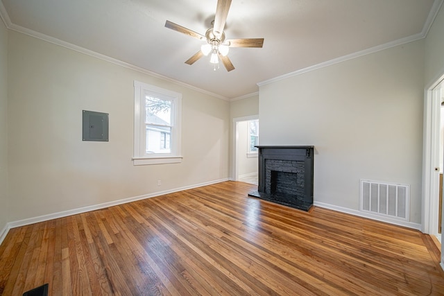 unfurnished living room featuring visible vents, electric panel, a fireplace with raised hearth, ceiling fan, and wood-type flooring