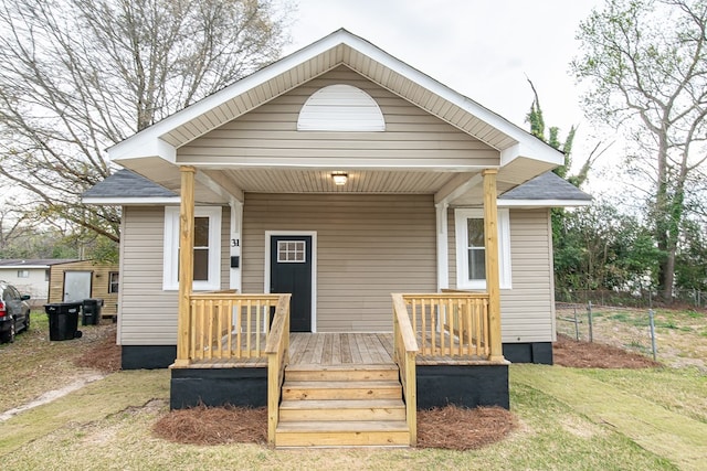 exterior space featuring fence and covered porch