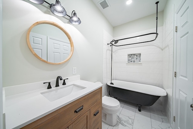 bathroom featuring visible vents, toilet, marble finish floor, a tub, and vanity