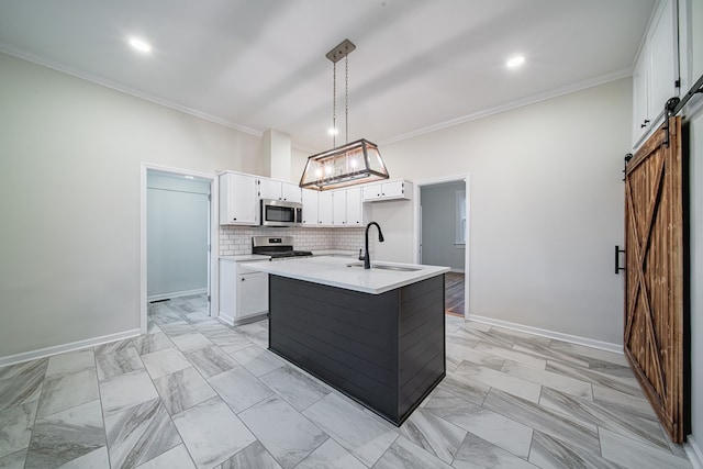 kitchen with a sink, ornamental molding, decorative backsplash, stainless steel appliances, and a barn door