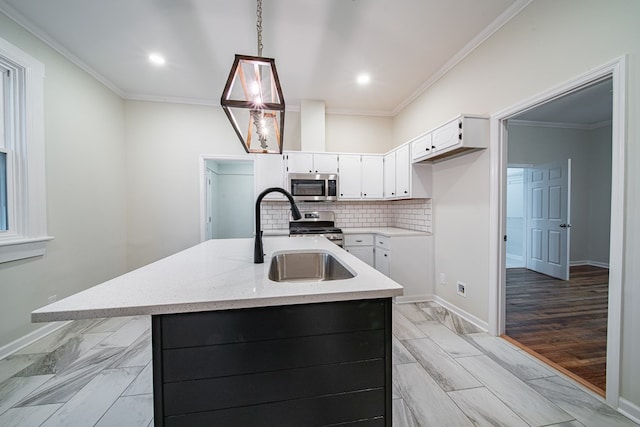 kitchen with backsplash, stainless steel appliances, crown molding, and a sink