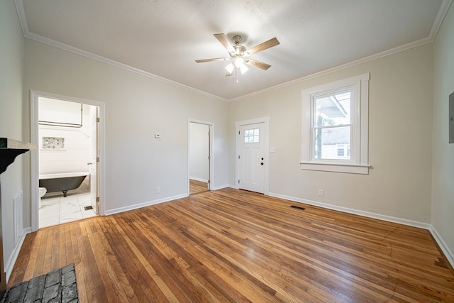 unfurnished living room featuring baseboards, ornamental molding, a ceiling fan, and hardwood / wood-style flooring