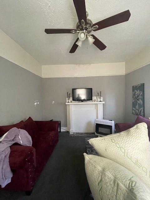 living room featuring a textured ceiling, heating unit, ceiling fan, and carpet floors