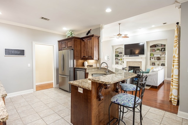71 Greystone Ct, Smiths Station, AL 36877 - kitchen with stainless steel appliances, a sink, light tile patterned floors, crown molding, and a ceiling fan