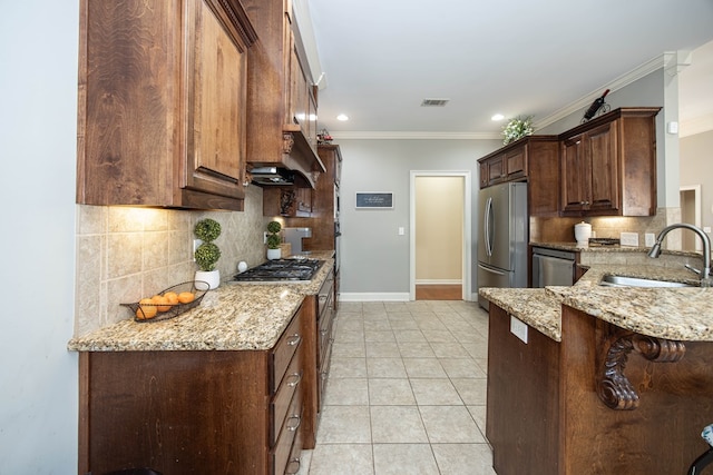 71 Greystone Ct, Smiths Station, AL 36877 - kitchen with a sink, appliances with stainless steel finishes, tasteful backsplash, crown molding, and light stone countertops