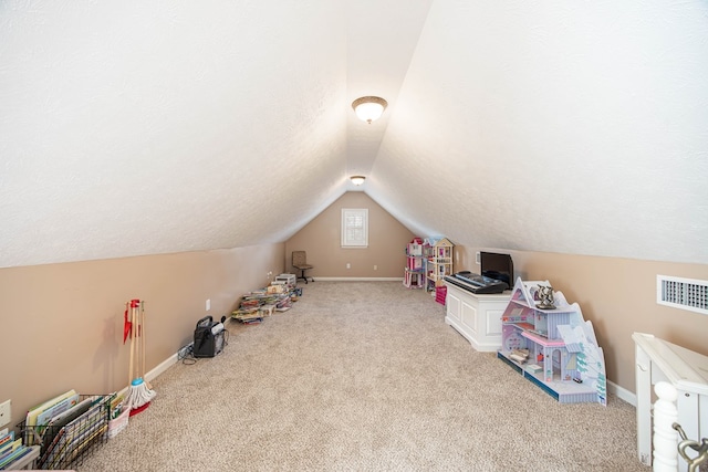 71 Greystone Ct, Smiths Station, AL 36877 - rec room featuring lofted ceiling, carpet floors, baseboards, and a textured ceiling