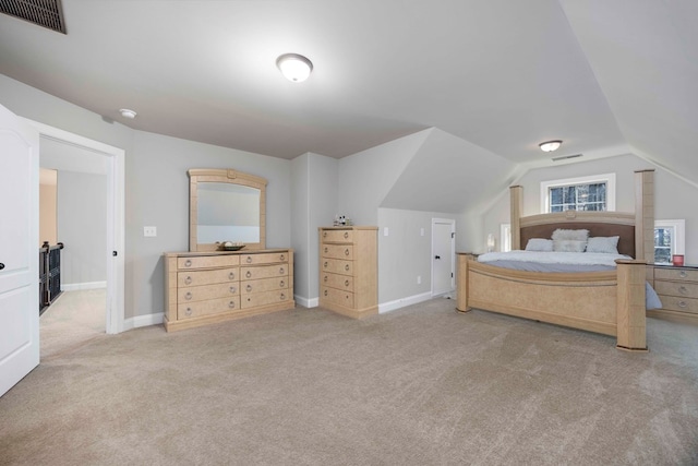 carpeted bedroom with visible vents, baseboards, and vaulted ceiling