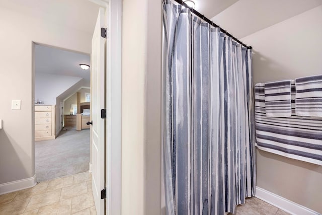 full bath with tile patterned floors, curtained shower, and baseboards