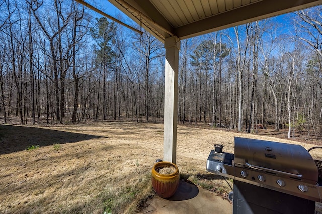 view of yard featuring a forest view