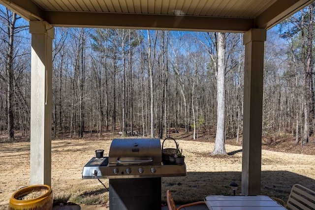 view of yard featuring a forest view