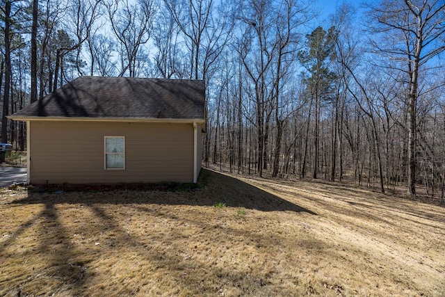 exterior space featuring roof with shingles