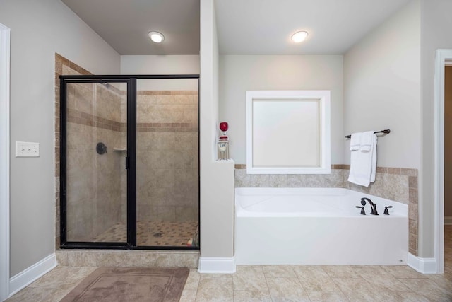 full bathroom featuring tile patterned floors, a shower stall, and a garden tub