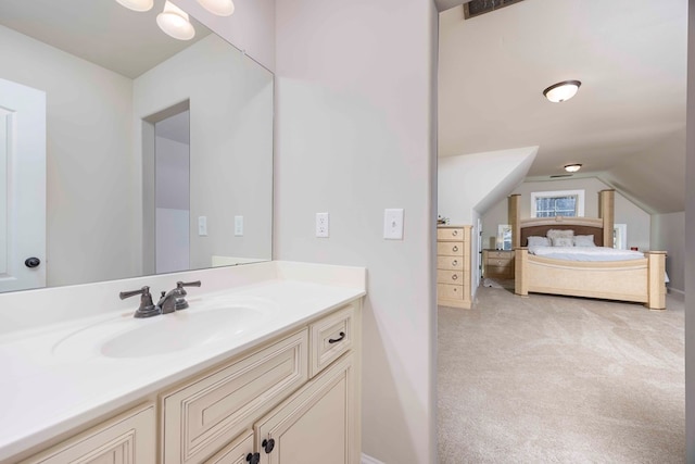 bathroom with vanity and vaulted ceiling