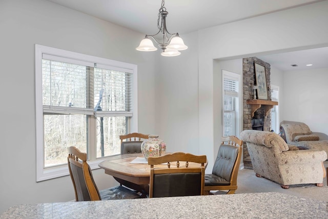 carpeted dining area featuring a notable chandelier