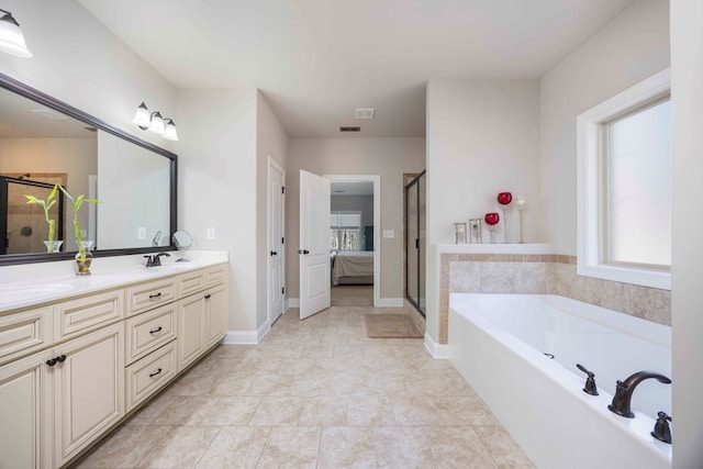 full bathroom with baseboards, double vanity, a stall shower, a garden tub, and connected bathroom