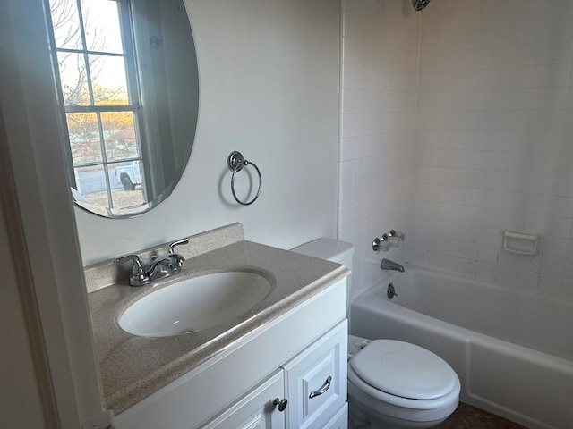 full bathroom featuring toilet, vanity, and washtub / shower combination