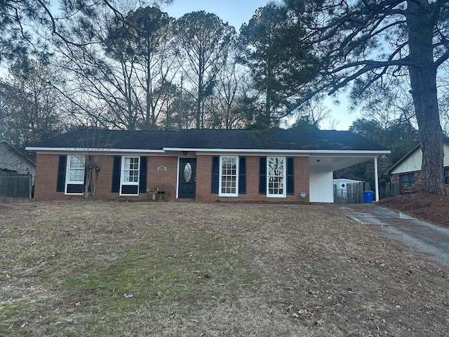 ranch-style home featuring a carport