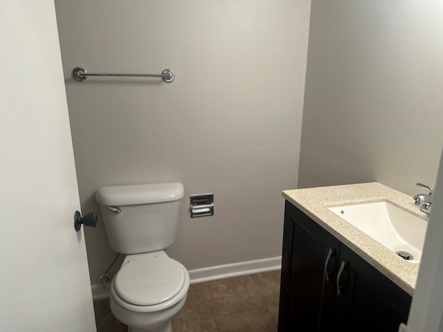 bathroom featuring toilet and vanity