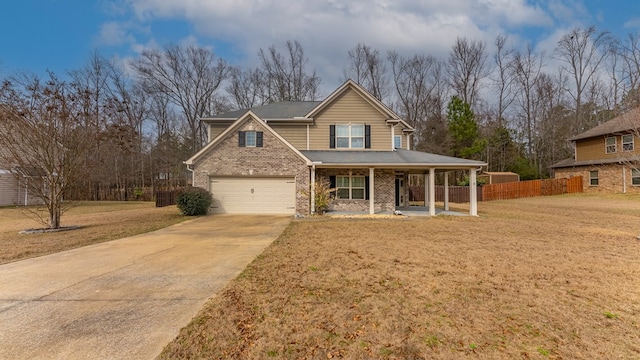 view of front of house with brick siding, a front yard, fence, a porch, and driveway