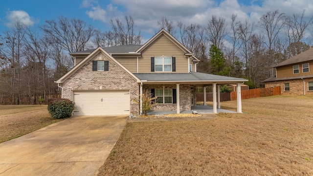 view of front of house with brick siding, a front yard, covered porch, and driveway