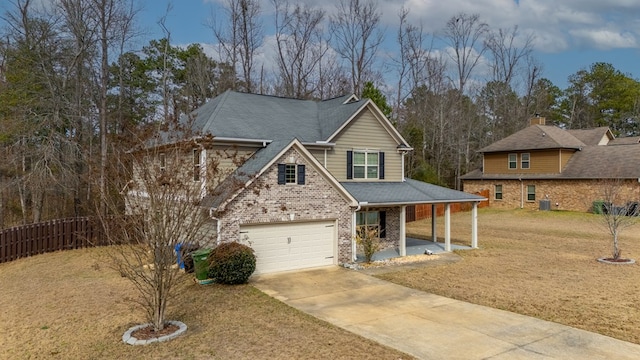 view of front of home featuring brick siding, concrete driveway, and a front lawn