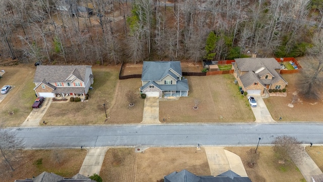 birds eye view of property with a wooded view