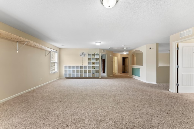 unfurnished room featuring baseboards, carpet floors, and visible vents