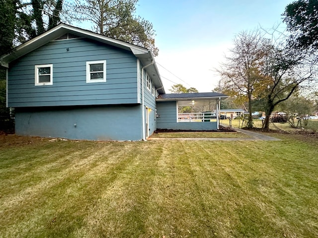 back of house with a lawn