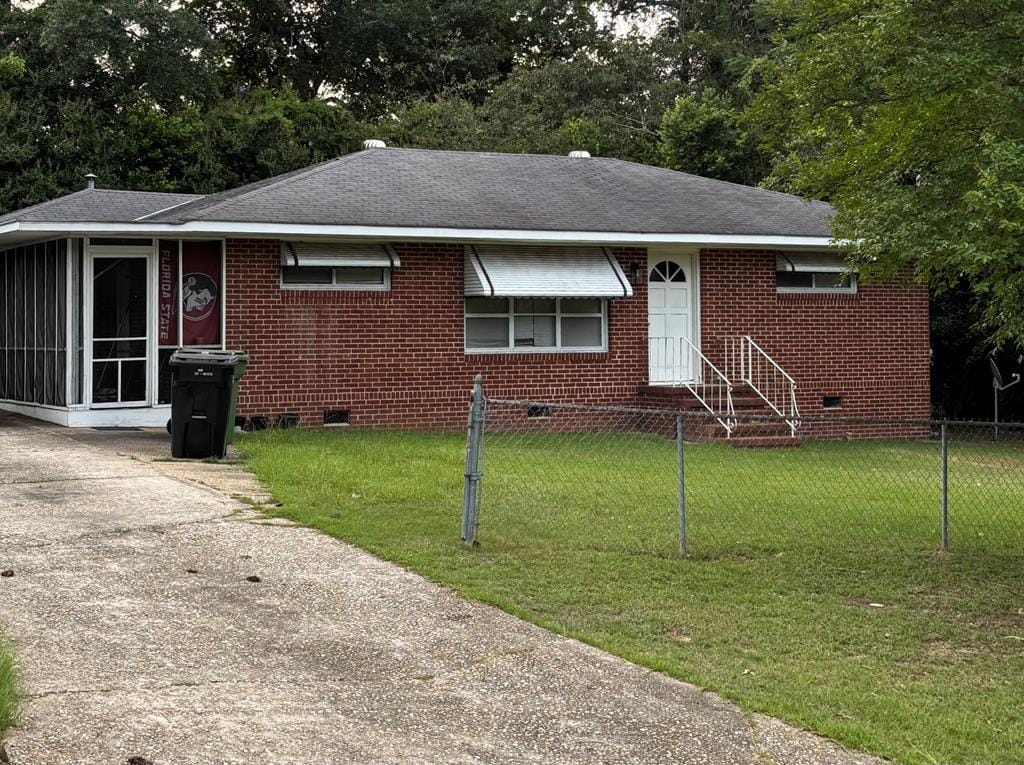 438 Claradon Ave, Columbus, GA 31906 - view of front facade with crawl space, brick siding, and roof with shingles