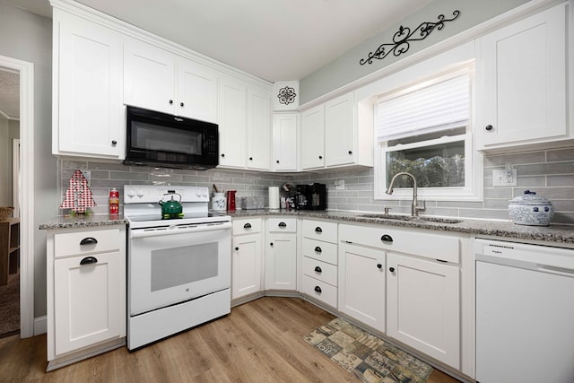 kitchen with white cabinetry, sink, light hardwood / wood-style floors, and white appliances