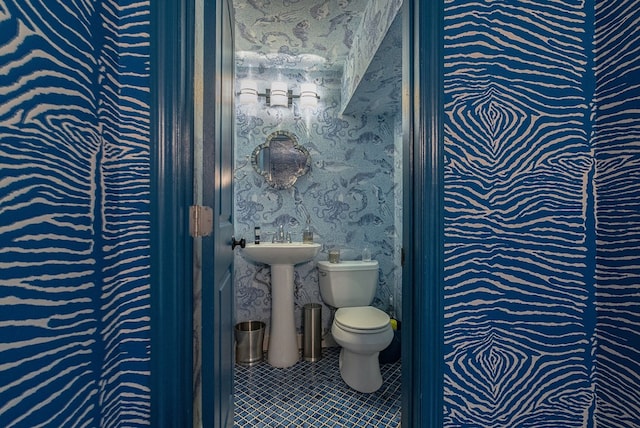 bathroom featuring tile patterned flooring and toilet