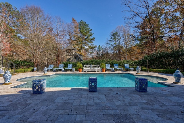 view of swimming pool with a patio