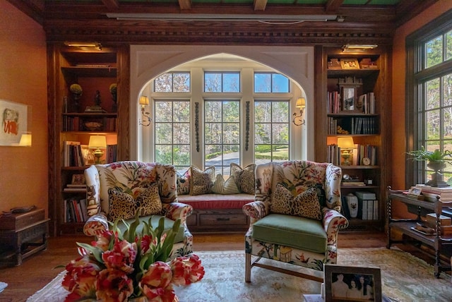 sitting room featuring built in shelves and hardwood / wood-style flooring