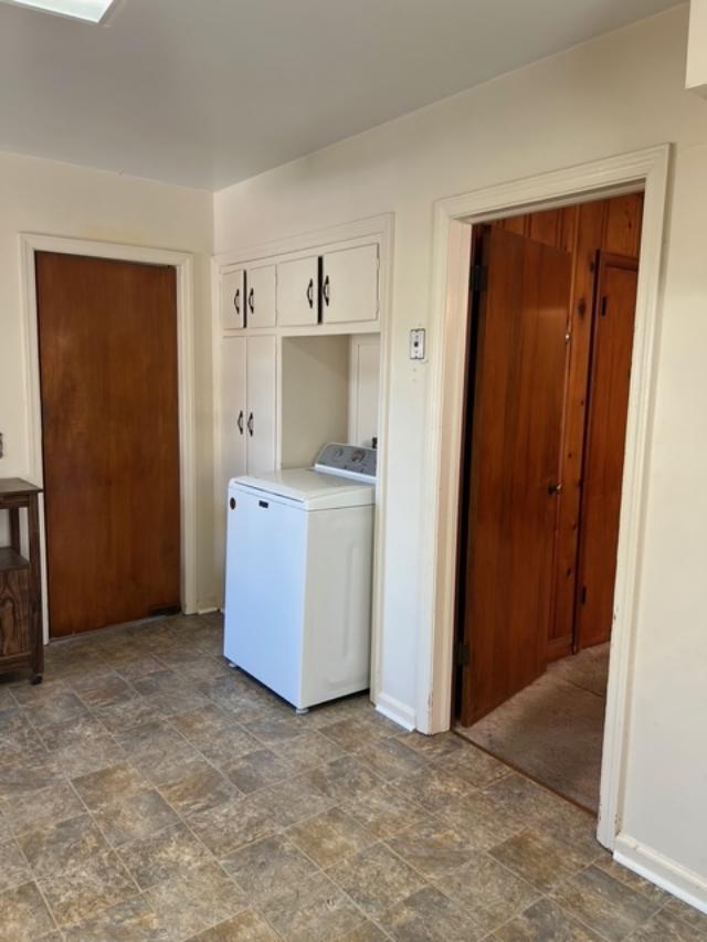 4332 Fay Dr, Columbus, GA 31907 - kitchen with washer / clothes dryer, gas range oven, a sink, light countertops, and white cabinetry