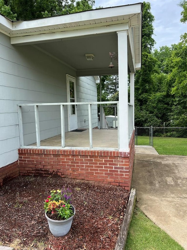 view of patio / terrace featuring covered porch and fence